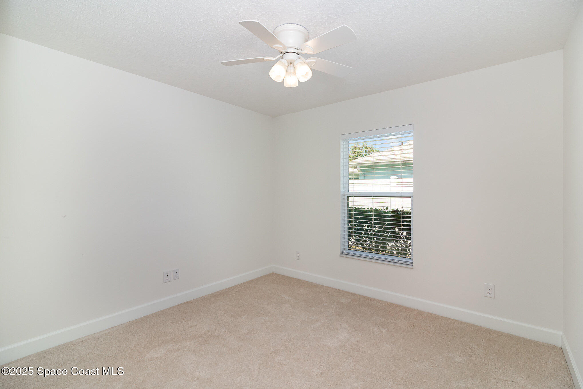 691 Belvedere Road Northwest Palm Bay, FL 32907 - Photo 16 of 26 an empty room with a window and a ceiling fan