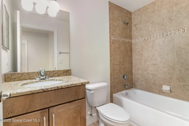 a view of a storage and utility room with granite countertop cabinets