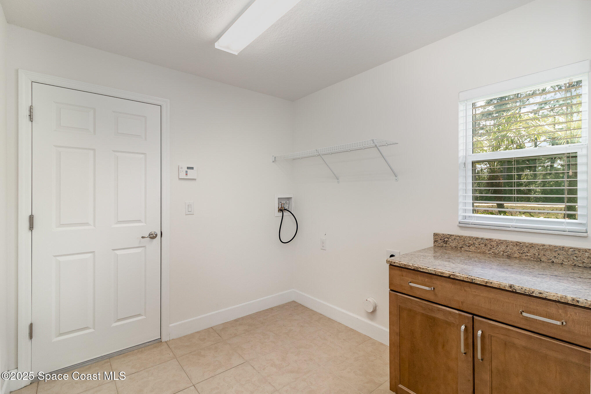 691 Belvedere Road Northwest Palm Bay, FL 32907 - Photo 18 of 26 a view of a storage and utility room with granite countertop cabinets