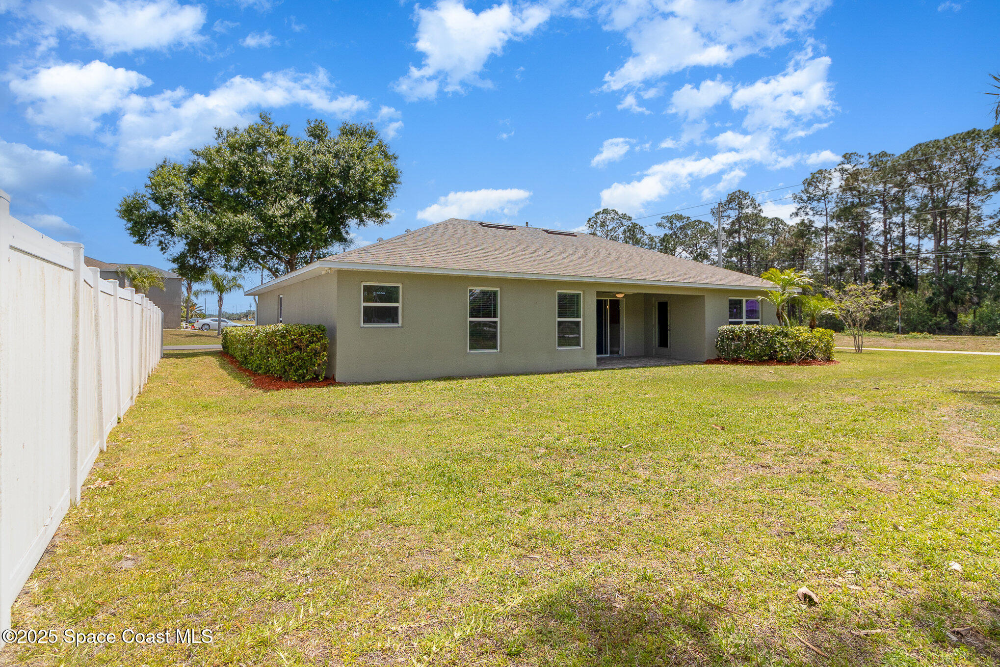 691 Belvedere Road Northwest Palm Bay, FL 32907 - Photo 23 of 26 a front view of a house with a garden