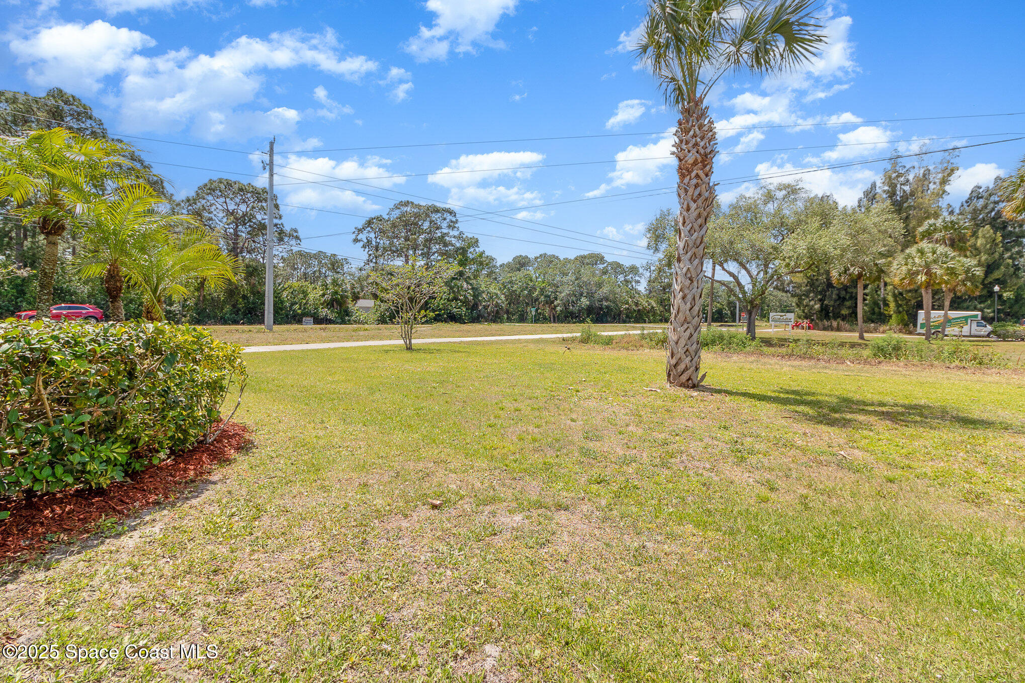 691 Belvedere Road Northwest Palm Bay, FL 32907 - Photo 24 of 26 a view of yard with swimming pool and green space
