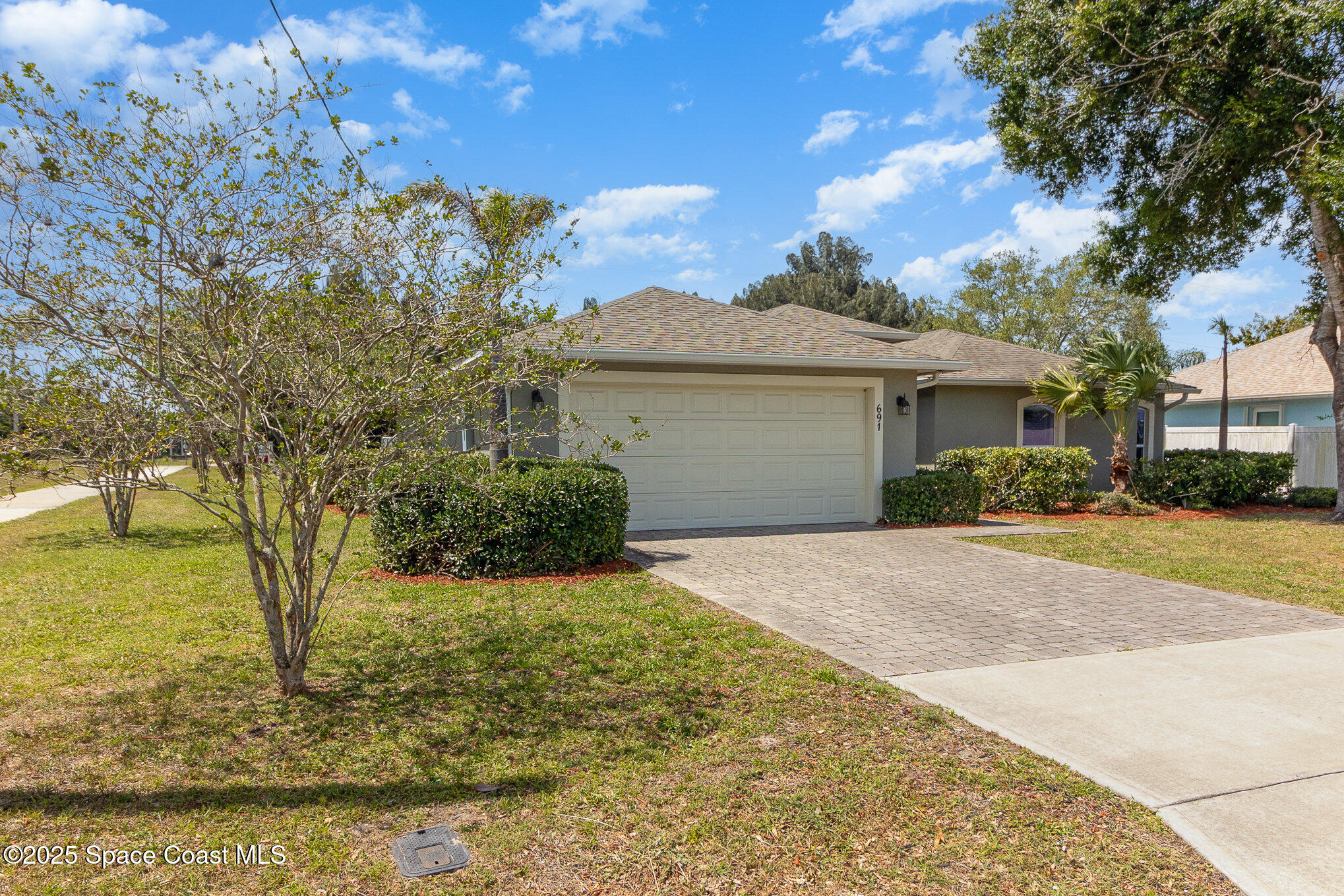 691 Belvedere Road Northwest Palm Bay, FL 32907 - Photo 3 of 26 a front view of a house with a yard