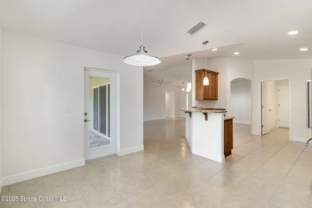 a view of a kitchen with a sink and a refrigerator