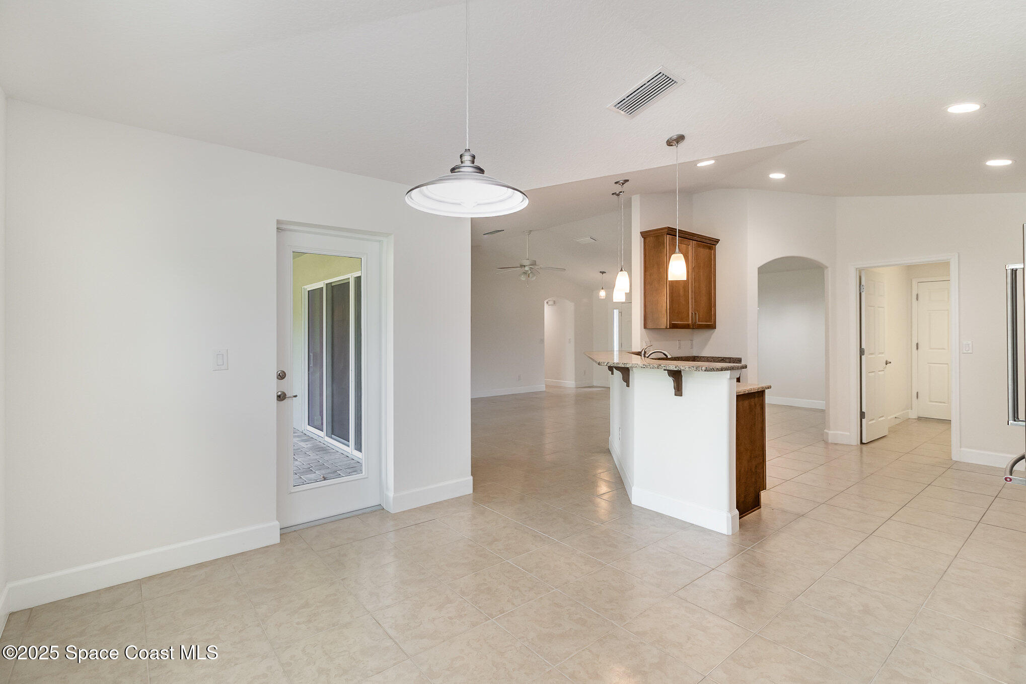 691 Belvedere Road Northwest Palm Bay, FL 32907 - Photo 8 of 26 a view of a kitchen with a sink and a refrigerator
