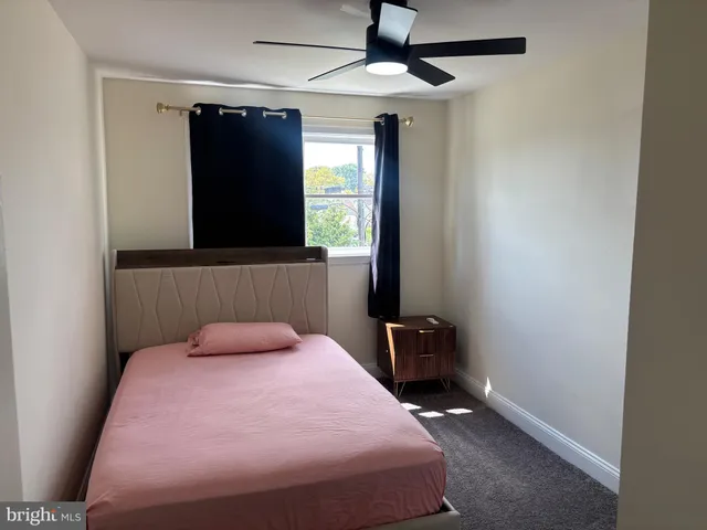 a bedroom with a bed and a flat tv screen