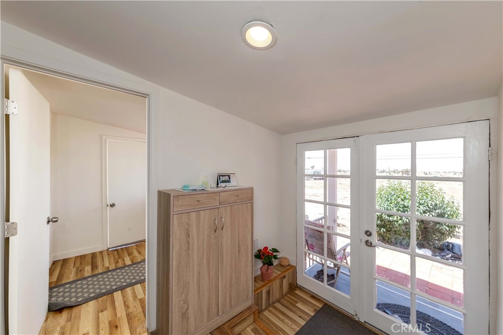 7127 Phelan Road Phelan, CA 92371 - Photo 14 of 44 a view of a hallway to a livingroom with wooden floor and windows