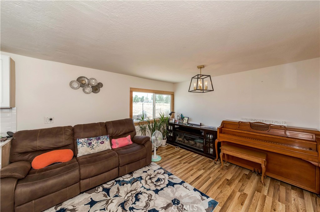 7127 Phelan Road Phelan, CA 92371 - Photo 15 of 44 a living room with furniture and wooden floor