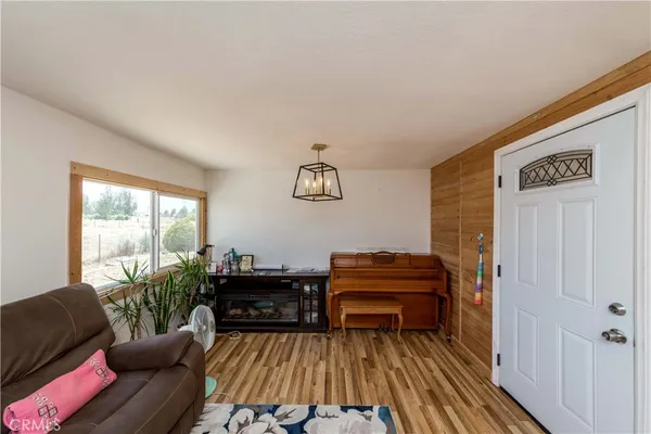 a living room with furniture and a piano
