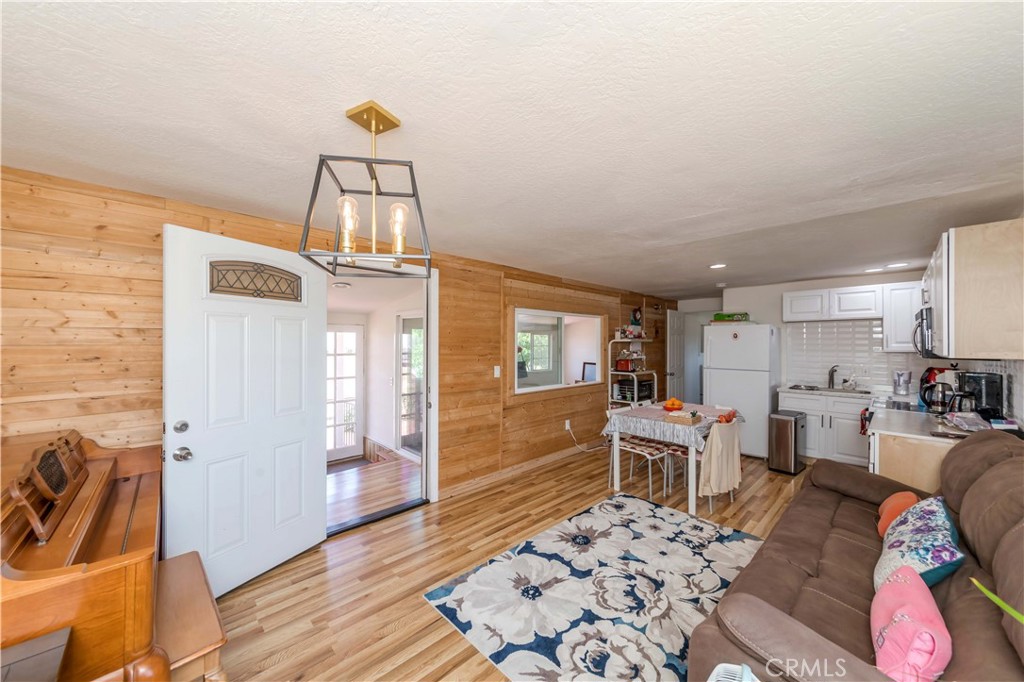 7127 Phelan Road Phelan, CA 92371 - Photo 20 of 44 a living room with furniture a rug and a chandelier