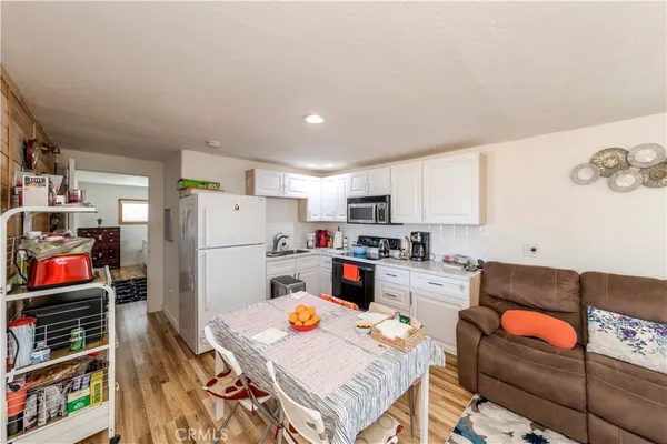 a kitchen with stainless steel appliances a refrigerator and a stove top oven