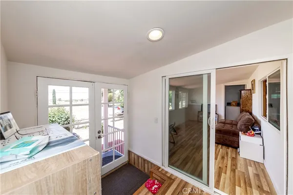 a room with a bed and a balcony view