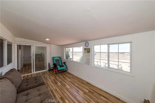 a living room with furniture and large windows