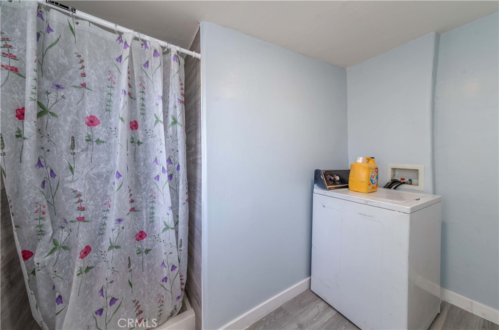 7127 Phelan Road Phelan, CA 92371 - Photo 28 of 44 a bathroom with a shower curtain and a sink