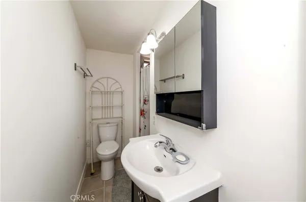 a bathroom with a sink a toilet and mirror