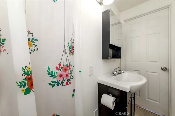 a bathroom with a sink mirror and vanity