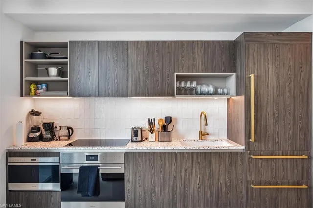 a bathroom with a toilet a sink and wooden floor