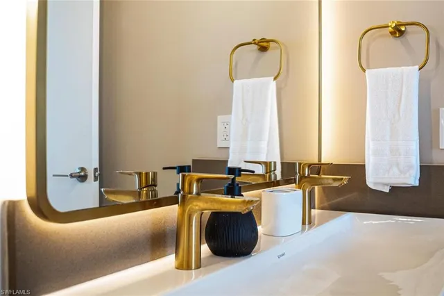 a white bath tub sitting next to a white toilet and vanity
