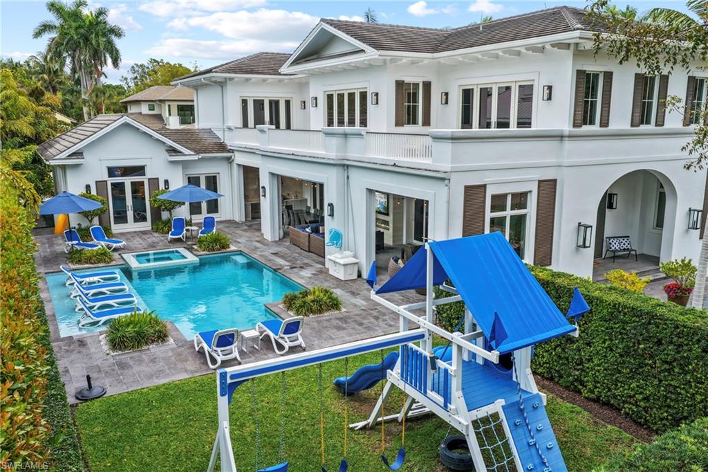 215 3rd Avenue North Naples, FL 34102 - Photo 43 of 47 Rear view of property with french doors, stucco siding, a patio area, and a pool with connected hot tub
