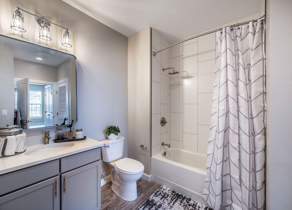 72 Flint Street, Unit 1406 Salem, MA 01970 - Photo 5 of 17 a bathroom with a sink a toilet and shower