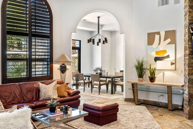 a living room with furniture and a potted plant