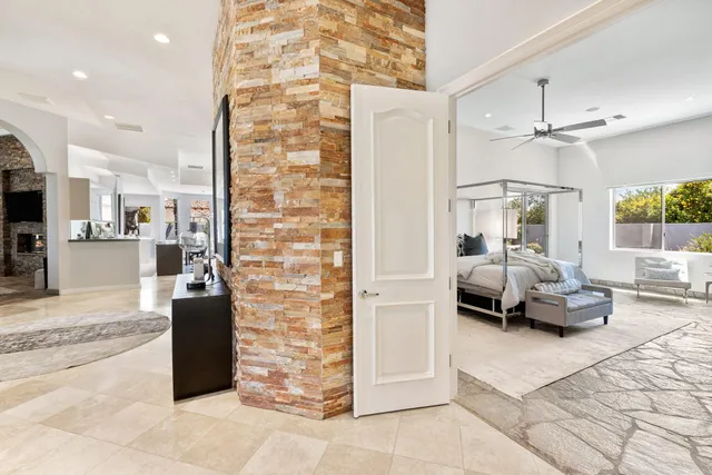 a bathroom with a granite countertop sink a toilet a mirror a vanity and shower