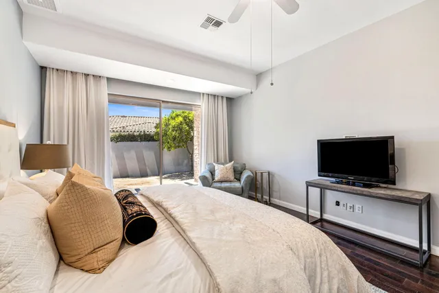 a view of a patio with a table and chairs under an umbrella