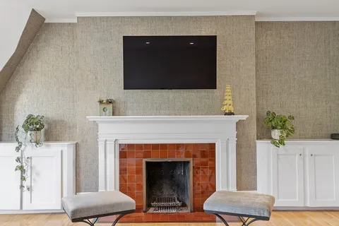 a living room with furniture and a fireplace