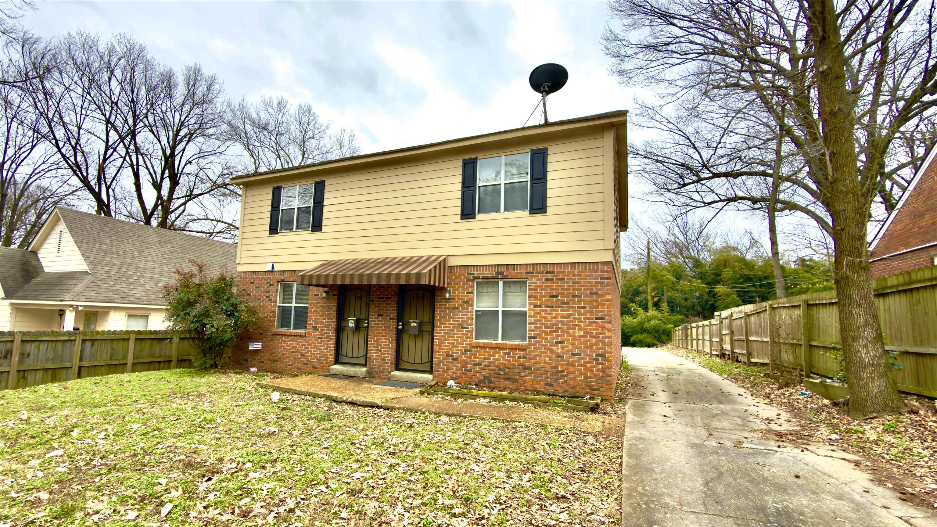 a view of a house with a yard and tree s