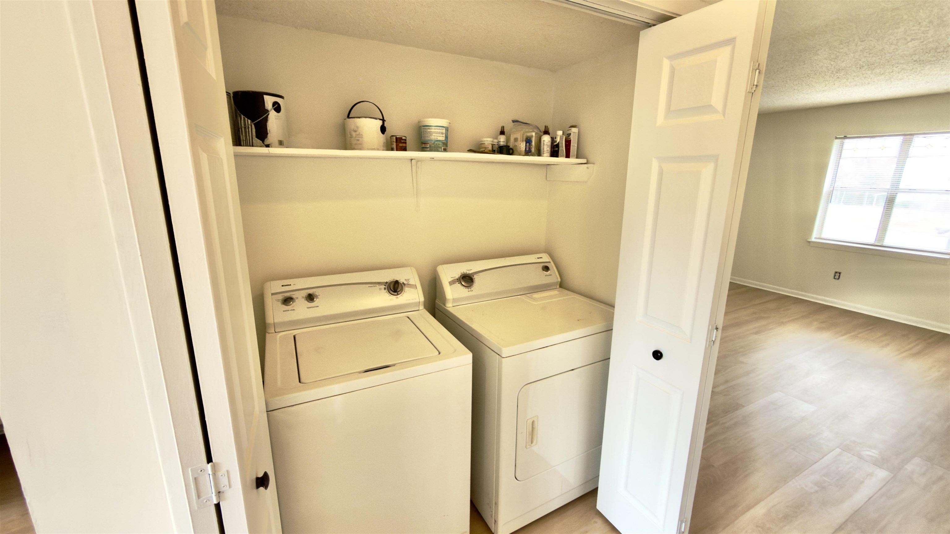 3799 Carnes Avenue Memphis, TN 38111 - Photo 13 of 16 Laundry area with a textured ceiling, light wood finished floors, and washer and dryer