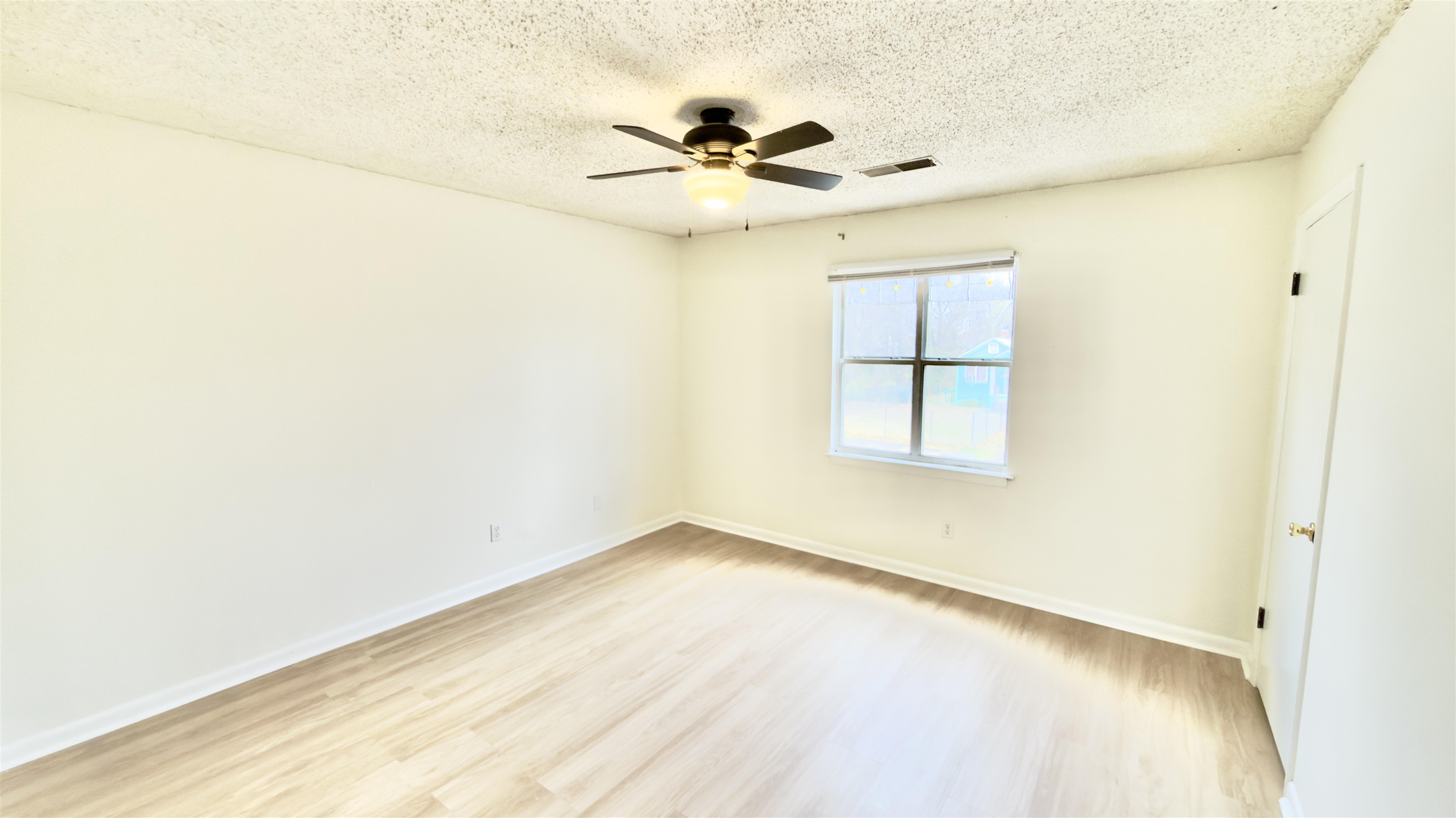 3799 Carnes Avenue Memphis, TN 38111 - Photo 16 of 16 an empty room with a window and a ceiling fan