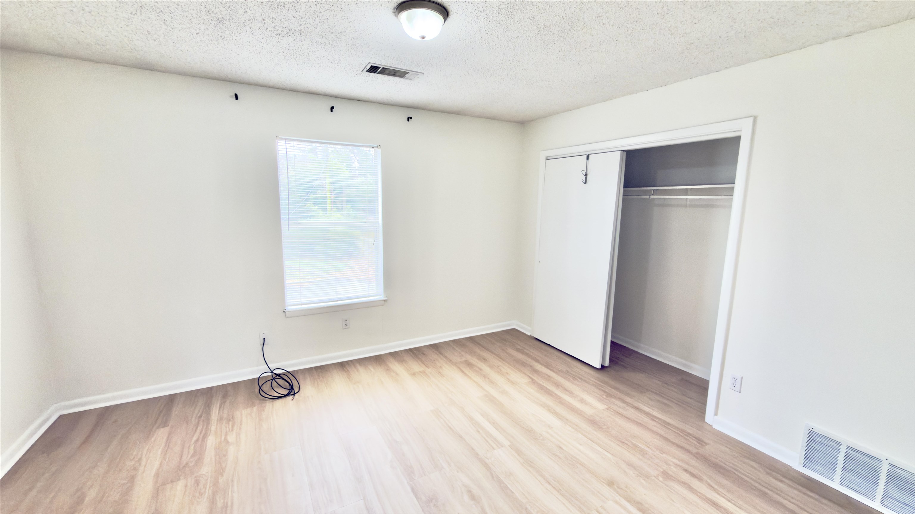 3799 Carnes Avenue Memphis, TN 38111 - Photo 6 of 16 an empty room with wooden floor cabinet and windows