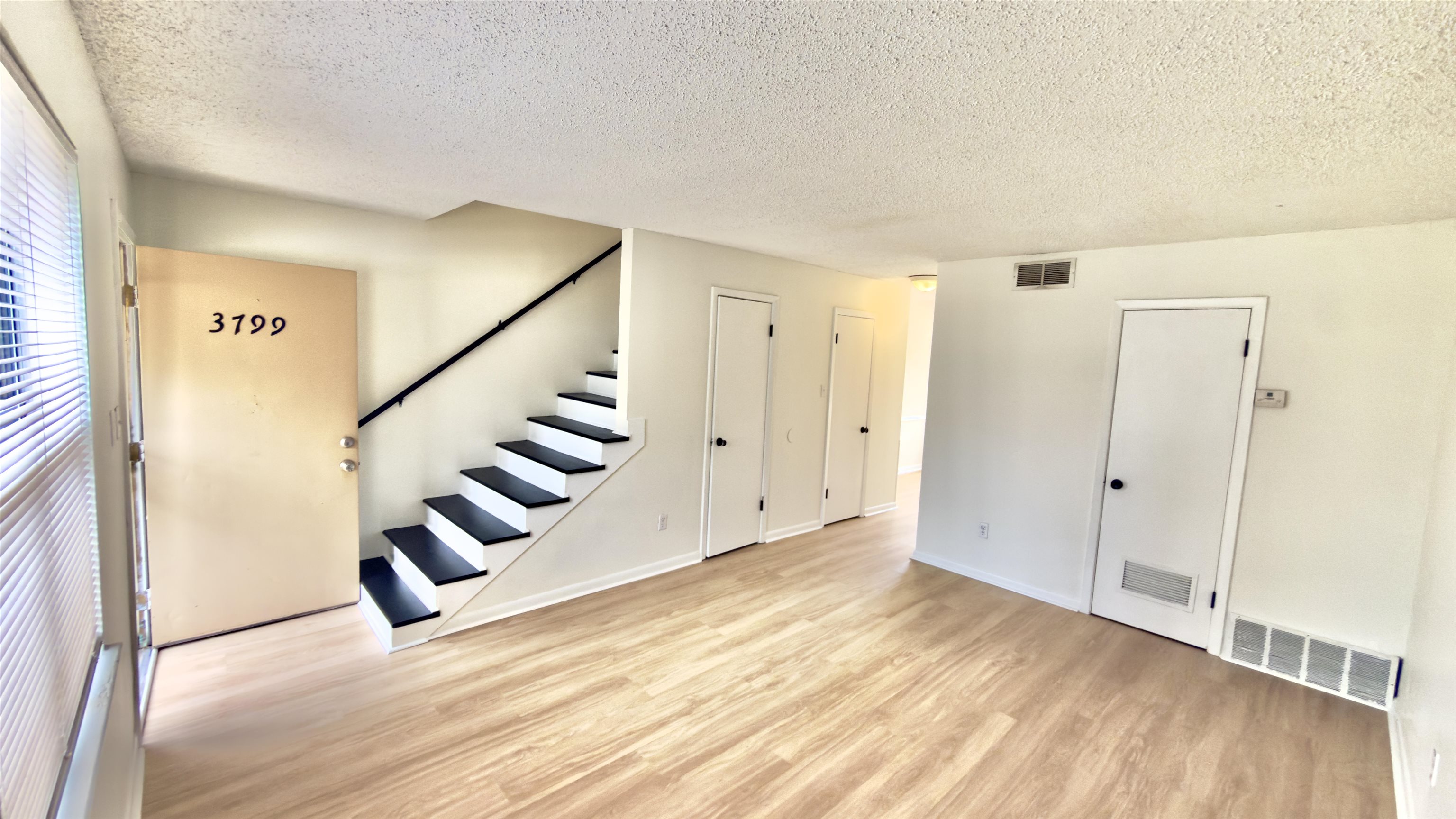 3799 Carnes Avenue Memphis, TN 38111 - Photo 9 of 16 Unfurnished living room featuring light wood-type flooring and a textured ceiling