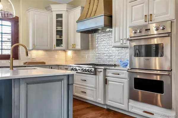 a kitchen with cabinets stainless steel appliances and a sink