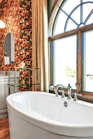 a bathroom with a bathtub and a window