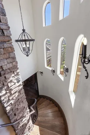 a view of a livingroom with wooden floor and a chandelier
