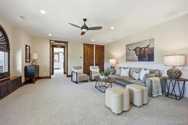 a living room with furniture ceiling fan and a window