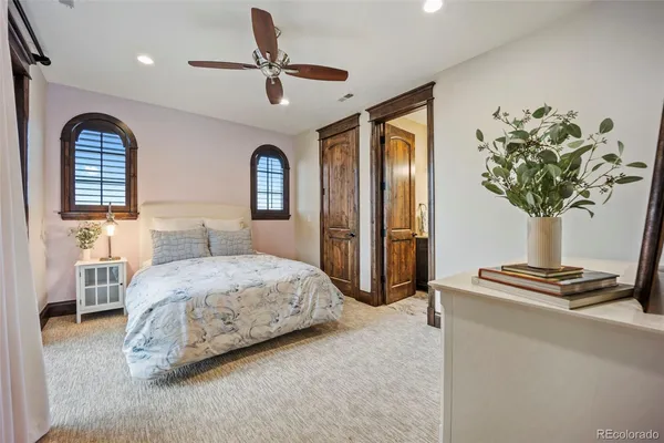 a bedroom with a bed and a potted plant