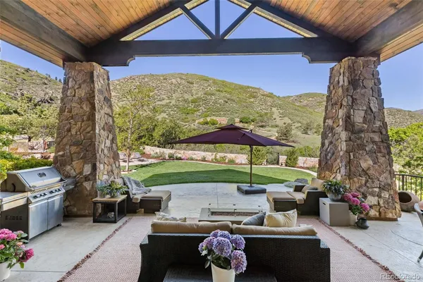 a balcony with furniture and a garden view