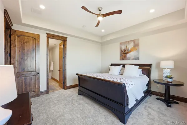 a spacious bedroom with a bed and a chandelier
