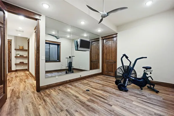 a view of a room with wooden floor and furniture