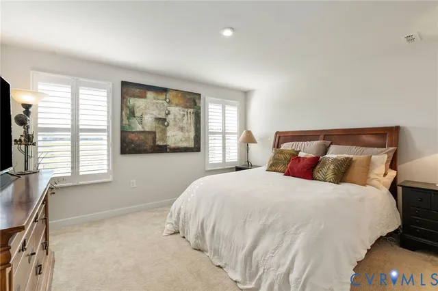 a en suite bathroom with a toilet a sink and a mirror