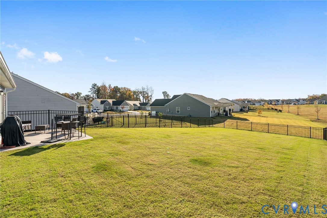7735 Medalist Lane New Kent, VA 23124 - Photo 23 of 47 Fenced backyard with a patio and a residential vie