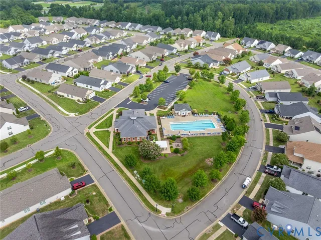 a living room with furniture a rug and a floor to ceiling window