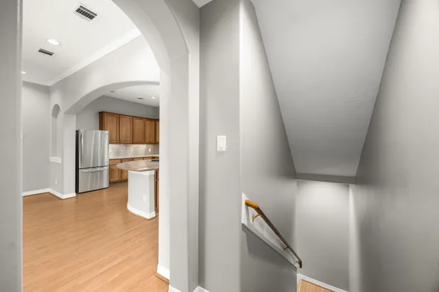 a view of an empty room with a fireplace and a window