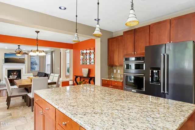 a kitchen with granite countertop a sink window and refrigerator