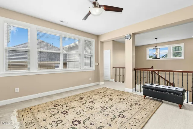 a view of a dining room with furniture and a chandelier