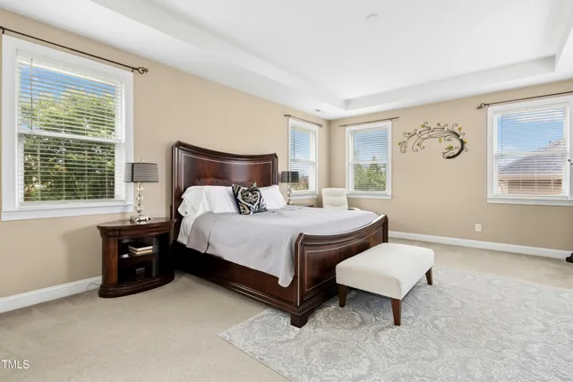 a bedroom with bed and wooden floor