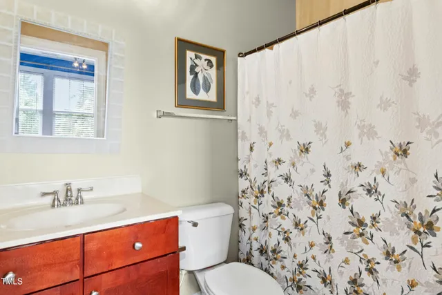 a bedroom with a bed and next to a window