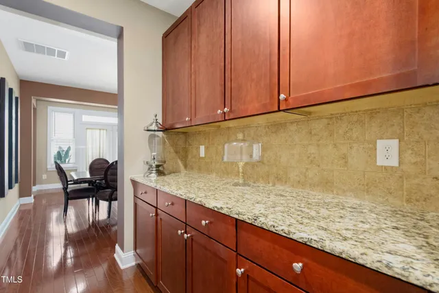 a living room with furniture a fireplace and a large window