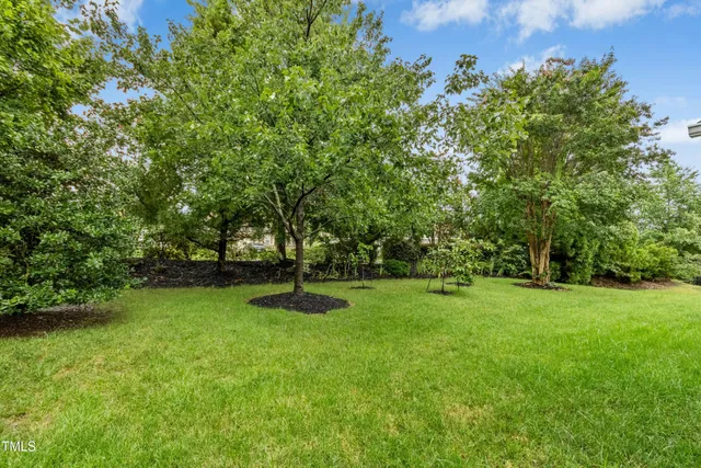 a view of a house with a yard and sitting area